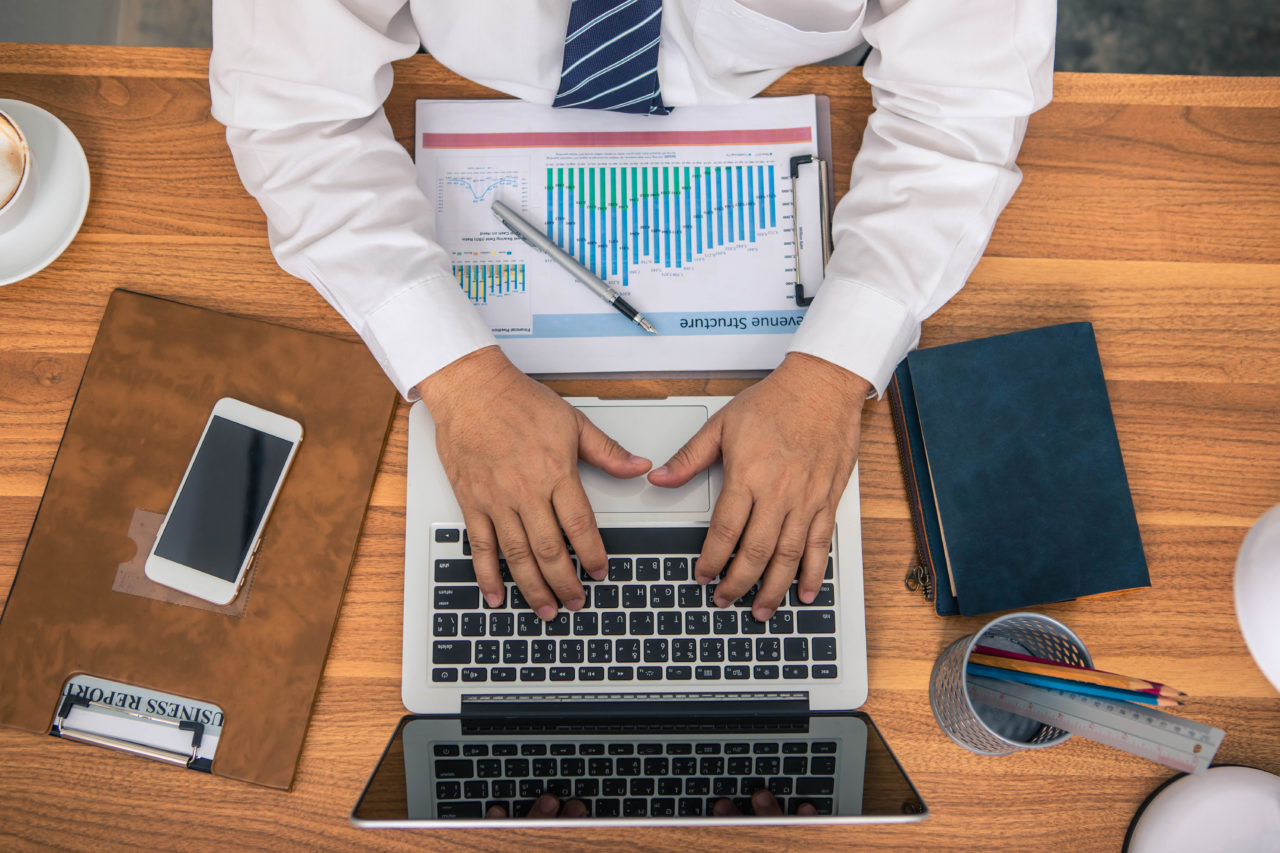 Business man looking at marketing analytics , top view